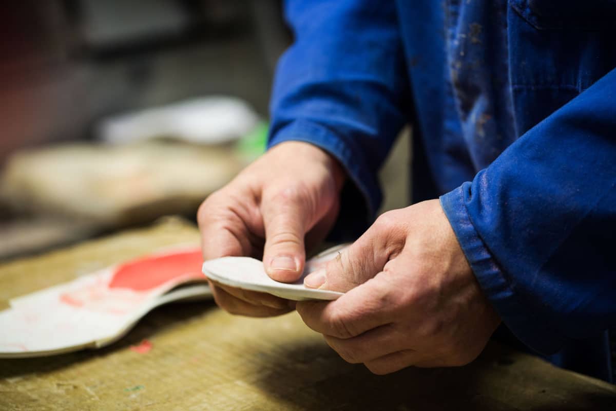 A Thera-Ped Pedorthist making custom footwear modifications.